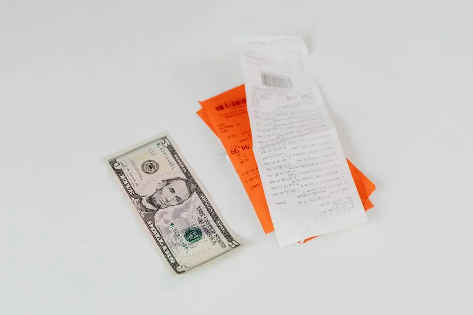 Close-up of a shopping receipt and cash, illustrative of the receipt-scan cashback apps described below